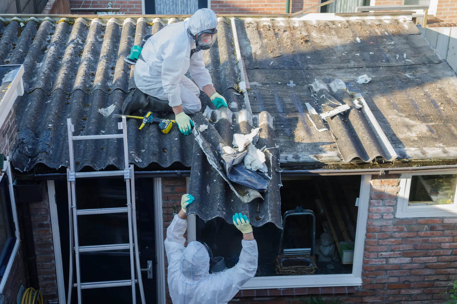 Surrey Asbestos licensed removal team in full PPE at a residential property in Surrey